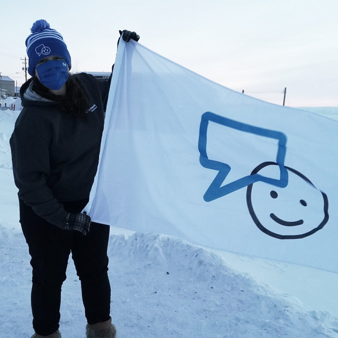 Gabby waving the Bell Let's Talk flag in Nunavut 