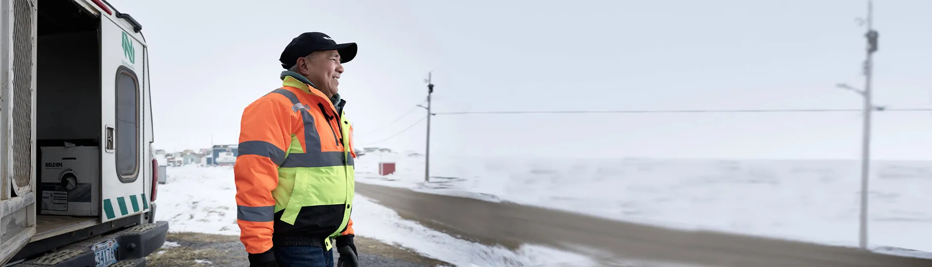 Technician leaving truck with tools with a background of a winter in Inuvik