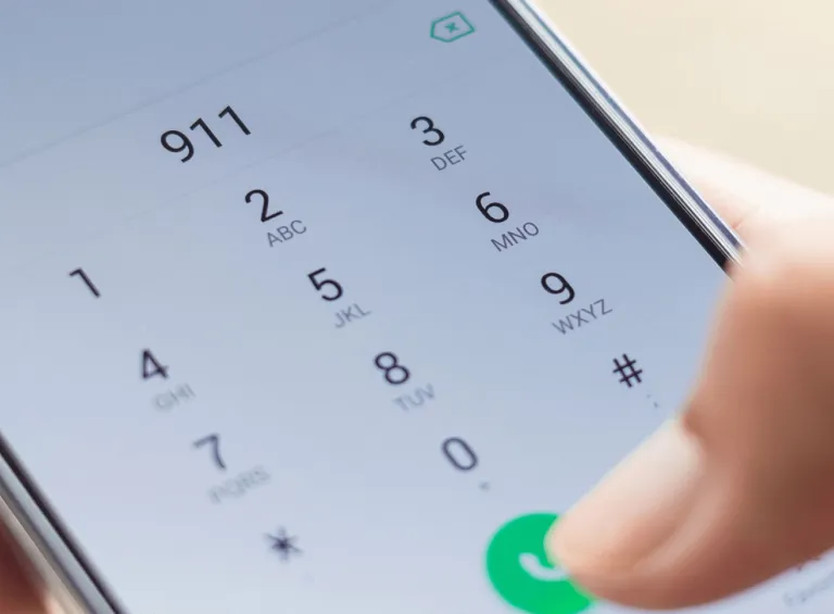 Person dialing 911 on their mobile