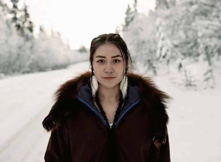 Woman standing on snowy road