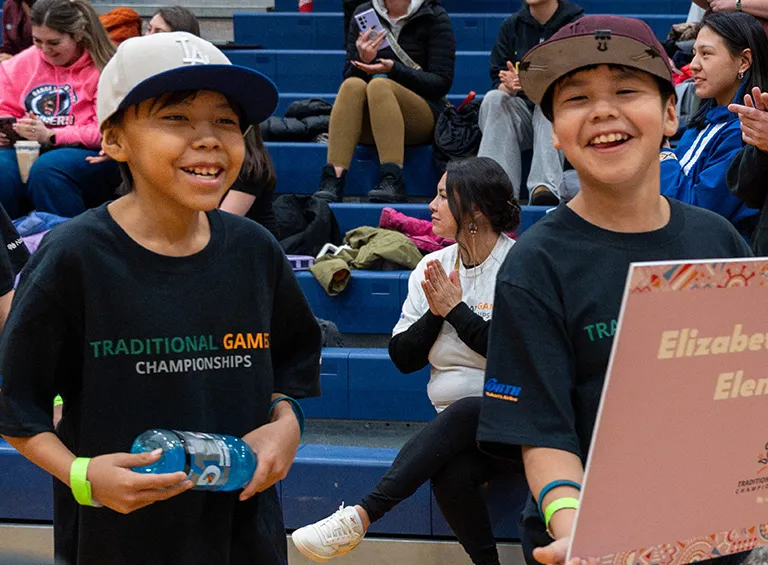 Teams enter the gym carrying their school banners while YKDFN drummers sing (Photo credit: Indigenous Sport Circle NWT) 