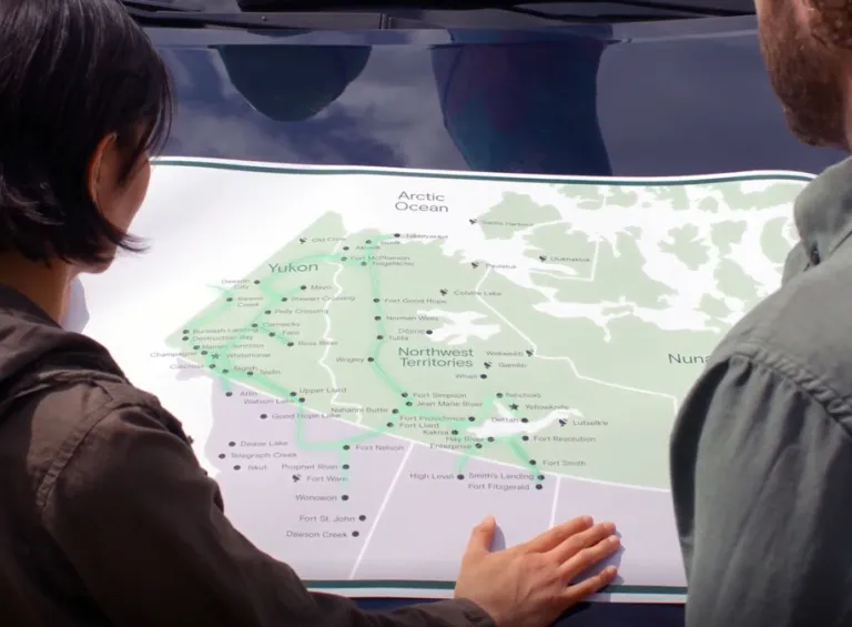 A couple looks at a map of the fibre network in the Yukon and NWT