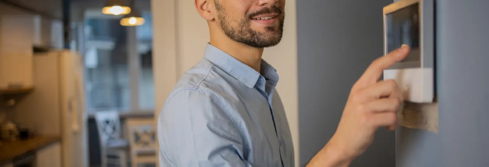 Person adjusting temperature using a smart thermostat