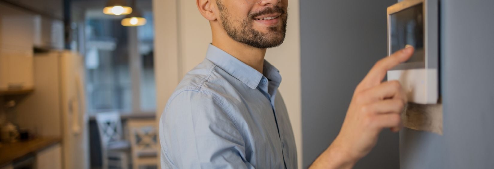 Person adjusting temperature using a smart thermostat
