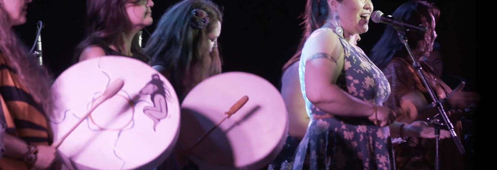 Photo of a female singer and drummers