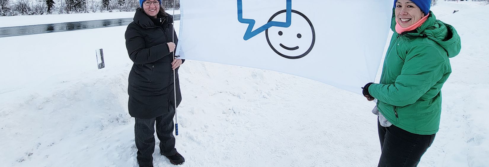 Northwestel employees holding the Bell Let's Talk flag outside in Yukon, Whitehorse Northwestel employees holding the Bell Let's Talk flag outside in Yukon, Whitehorse