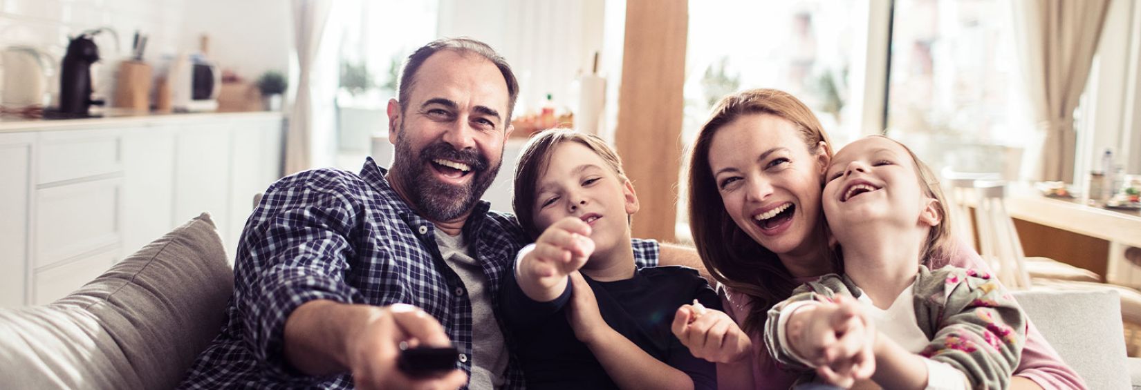 family watching TV and eating popcorn together
