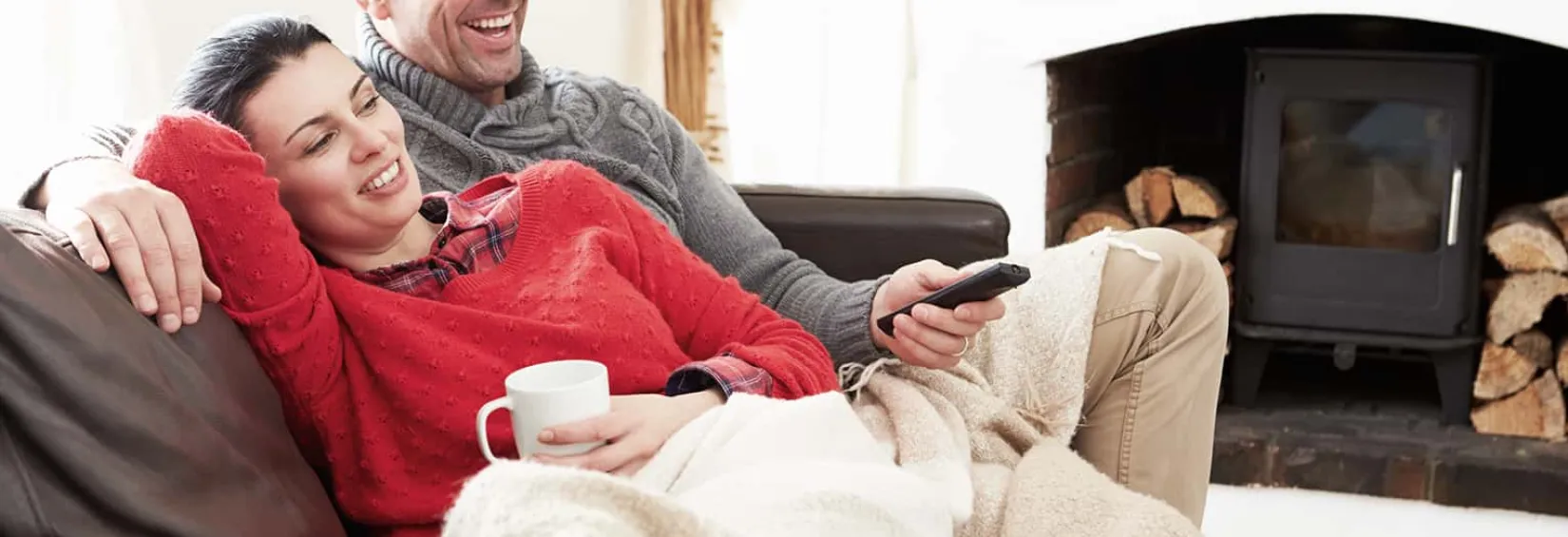 couple relaxing on couch watching tv