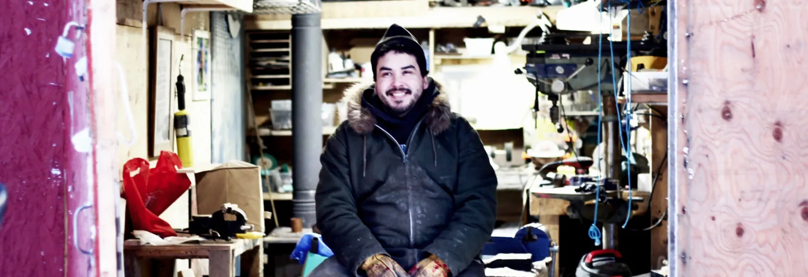 Nooks sitting in his workshop in Arviat, Nunavut