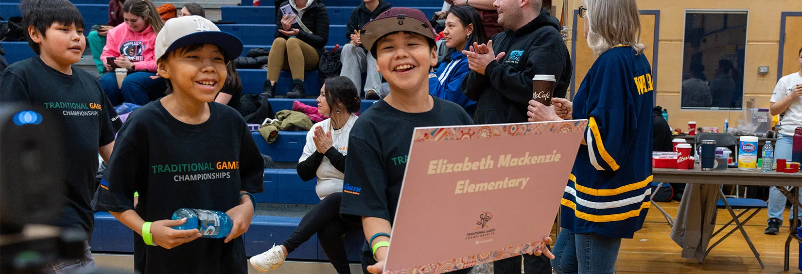Teams enter the gym carrying their school banners while YKDFN drummers sing (Photo credit: Indigenous Sport Circle NWT) 