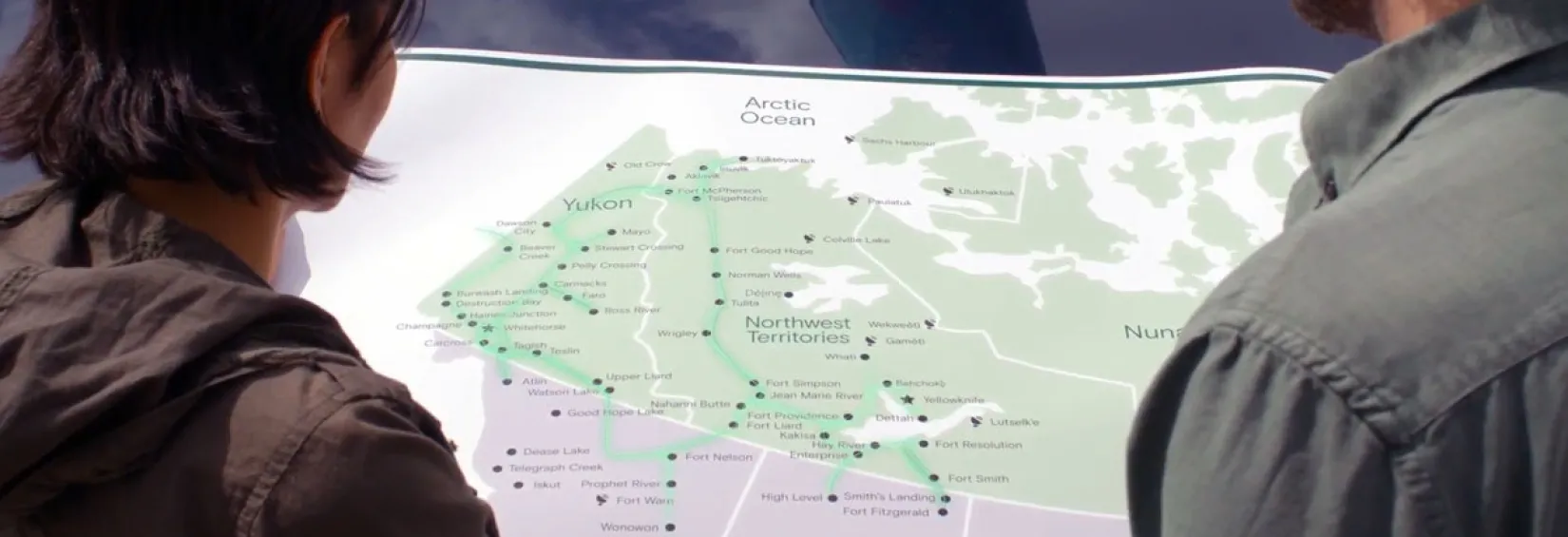 A couple looks at a map of the fibre network in the Yukon and NWT