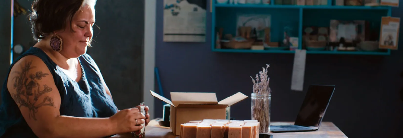 Joella Hogan, the proprietor of the Yukon Soaps Company, works with product at her shop in Mayo, Yukon Territory.