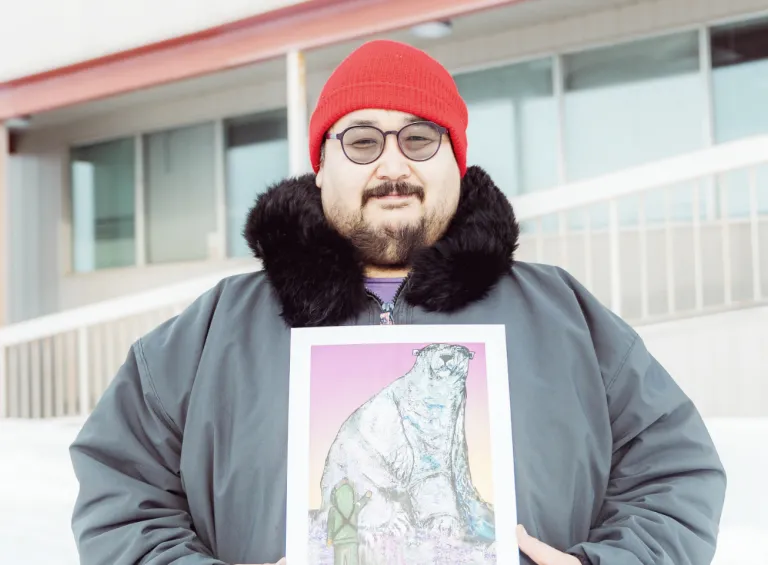 Joshua Qaumariaq holding his artwork - Nanurluk Shapeshifter. Photo by: Natalie Gillis Joshua Qaumariaq holding his artwork - Nanurluk Shapeshifter