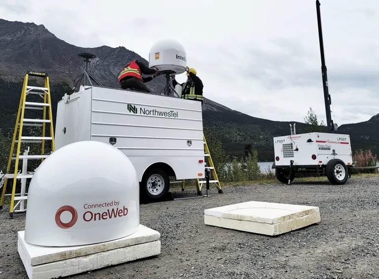 Tech's setting up OneWeb antennae at the Klondike Road Relay OneWeb antenna