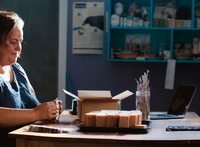 Joella Hogan, the proprietor of the Yukon Soaps Company, works with product at her shop in Mayo, Yukon Territory.